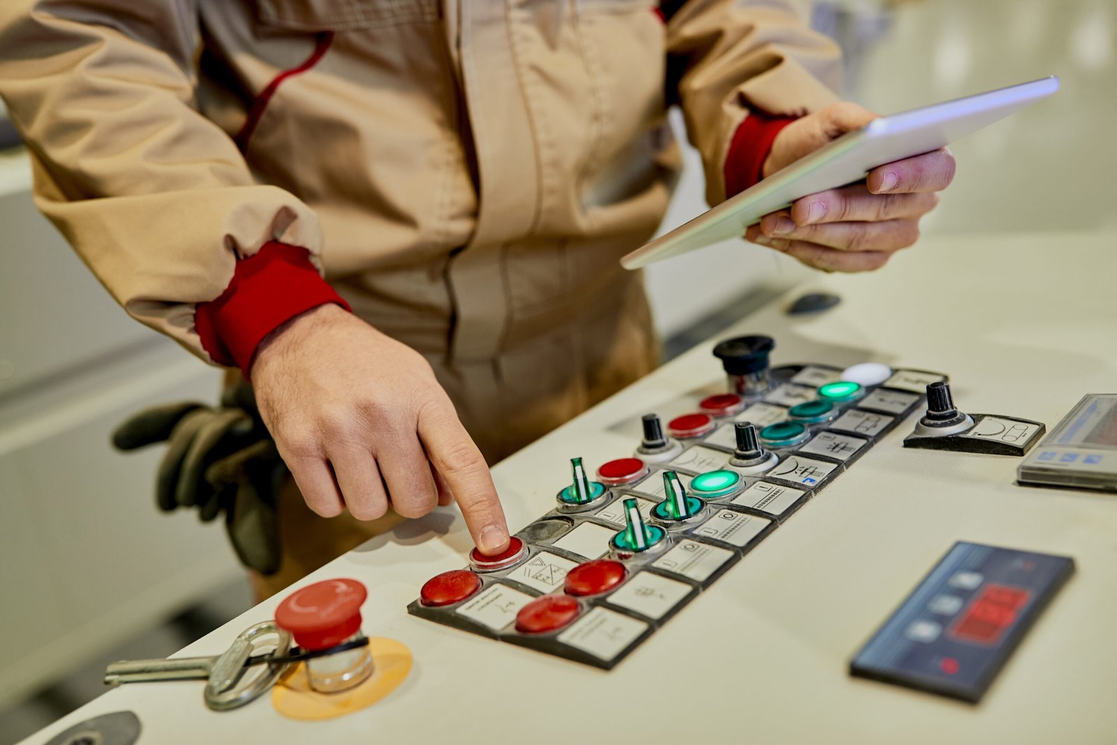 Engineer operating an automated industrial control system on the factory floor